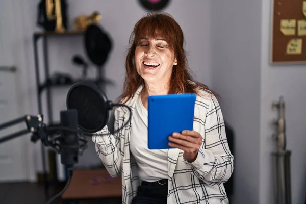Middle Age Woman Musician Singing Song Holding Touchpad Music Studio — Foto Stock