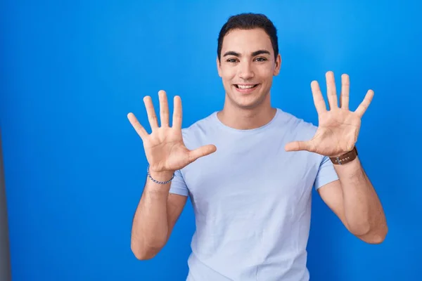 Young Hispanic Man Standing Blue Background Showing Pointing Fingers Number — Foto Stock