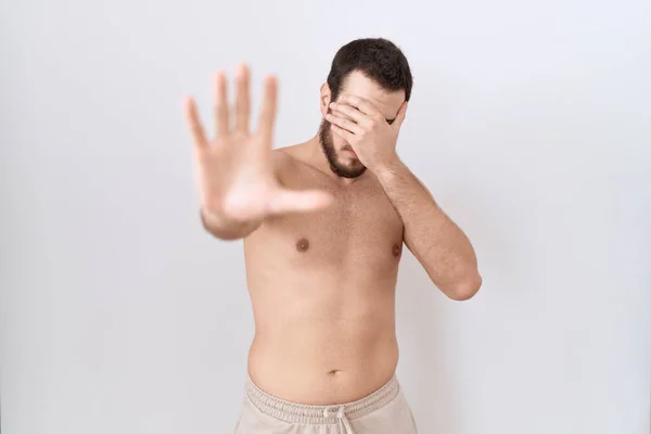 Young Hispanic Man Standing Shirtless White Background Covering Eyes Hands — Stock Photo, Image
