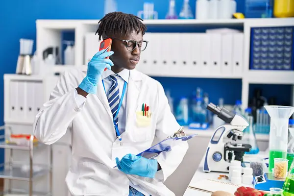African American Man Scientist Talking Smartphone Reading Document Laboratory — Stock Photo, Image