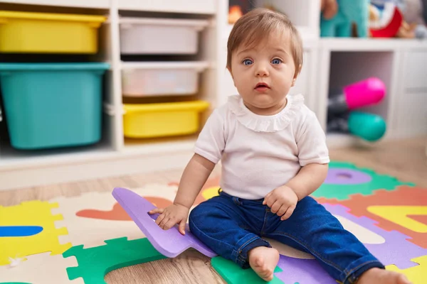 Adorable Hispanic Baby Sitting Floor Relaxed Expression Kindergarten — стоковое фото