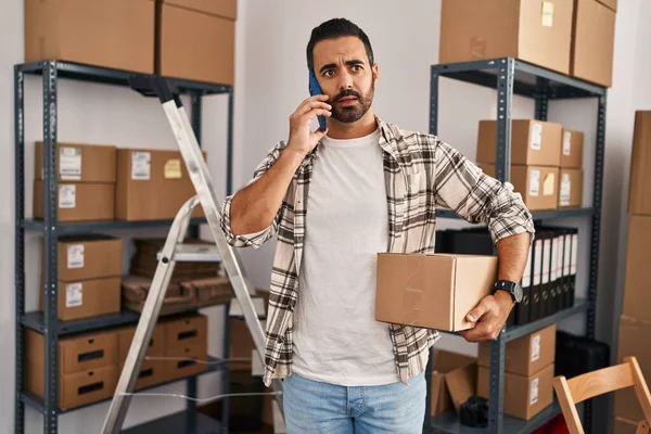 Young Hispanic Man Ecommerce Business Worker Talking Smartphone Holding Package — Stock Photo, Image