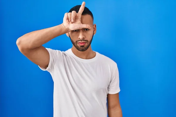 Young Hispanic Man Standing Blue Background Making Fun People Fingers — Stockfoto