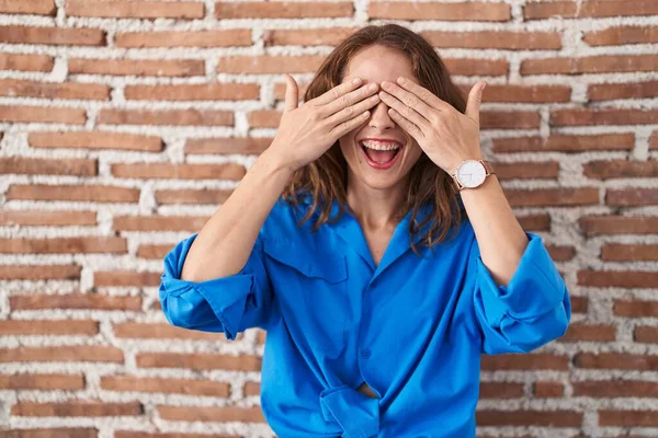 Beautiful Brunette Woman Standing Bricks Wall Covering Eyes Hands Smiling — Stock Photo, Image