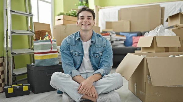 Young Hispanic Man Smiling Confident Sitting Floor New Home — Stok fotoğraf