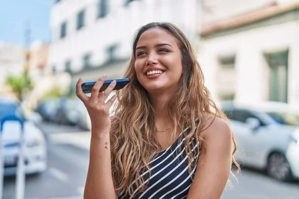 stock image Young beautiful hispanic woman smiling confident listening audio message by the smartphone at street