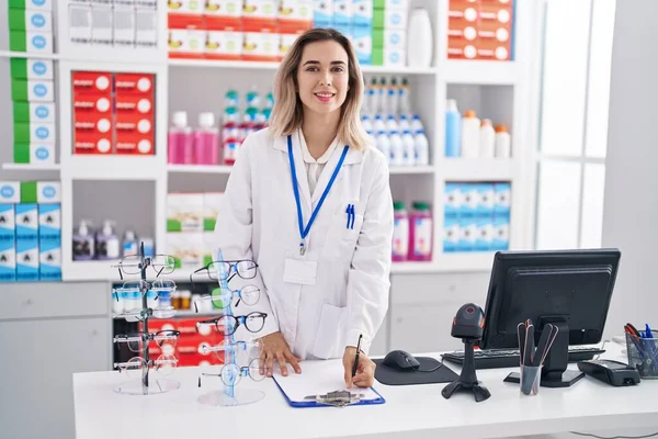 Young Woman Pharmacist Smiling Confident Writing Document Pharmacy — 스톡 사진