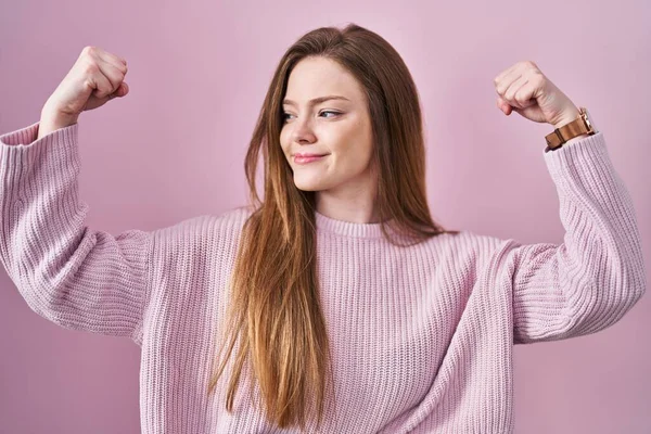 Young Caucasian Woman Standing Pink Background Showing Arms Muscles Smiling — Zdjęcie stockowe