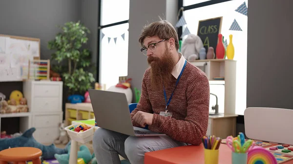Young Redhead Man Preschool Teacher Using Laptop Sitting Chair Kindergarten — Photo