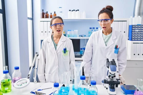 Young Mother Daughter Scientist Laboratory Scared Amazed Open Mouth Surprise — Stock Photo, Image