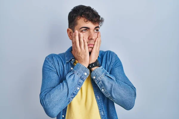 Young Hispanic Man Standing Blue Background Tired Hands Covering Face — Stock fotografie