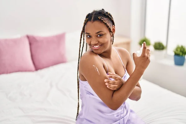 African American Woman Applying Skin Treatment Sitting Bed Bedroom — Stock Photo, Image