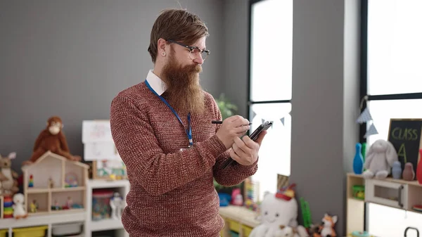 Young Redhead Man Preschool Teacher Writing Touchpad Standing Kindergarten — Stock Fotó