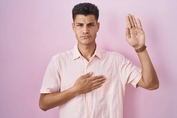 Young Hispanic Man Standing Pink Background Swearing Hand Chest Open — Stockfoto