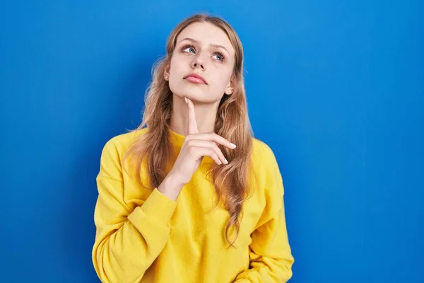 Young Caucasian Woman Standing Blue Background Thinking Concentrated Doubt Finger — Stockfoto