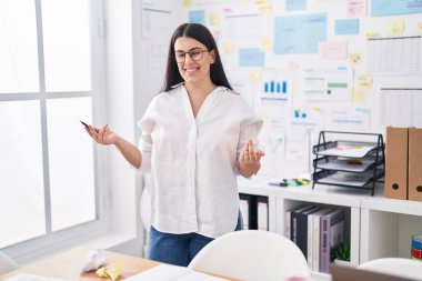 Young beautiful hispanic woman business worker smiling confident speaking at office