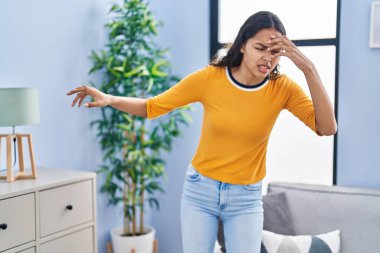 Young african american woman dizzy standing at home