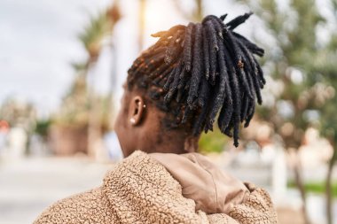 African american woman standing on back view at park