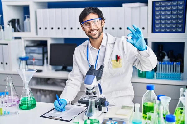 Young Hispanic Man Scientist Write Clipboard Holding Sample Laboratory — Stock Photo, Image