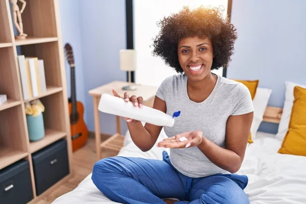 African American Woman Pouring Lotion Hand Sitting Bed Bedroom — 스톡 사진