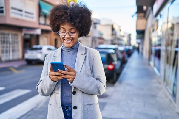 stock image African american woman executive smiling confident using smartphone at street