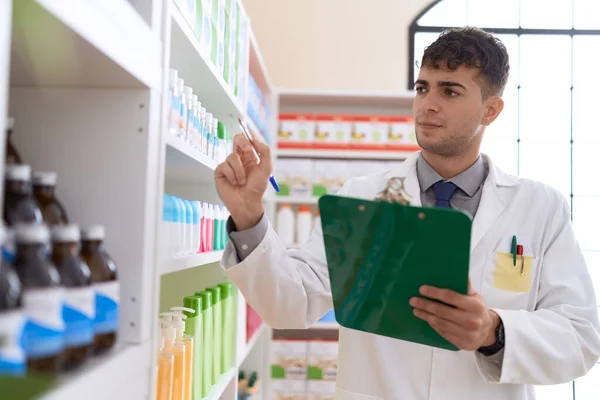 Young Hispanic Man Pharmacist Writing Clipboard Pharmacy — Stock Photo, Image