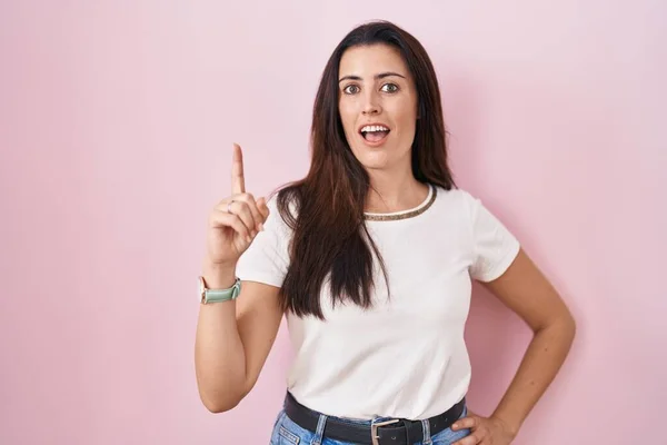Young Brunette Woman Standing Pink Background Pointing Finger Successful Idea — Stockfoto