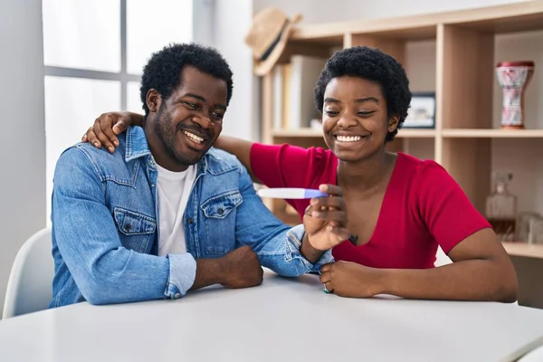 Young African American Couple Holding Pregnancy Test Result Looking Positive — Stock Photo, Image