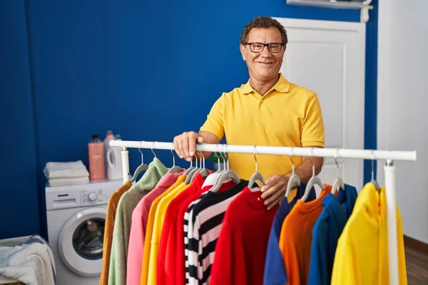 Middle Age Man Smiling Confident Leaning Clothes Rack Laundry Room —  Fotos de Stock