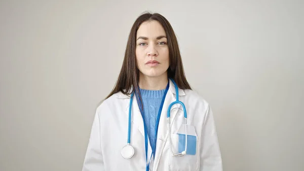 年轻的高加索女医生 严肃地站在孤立的白人背景之上 — 图库照片