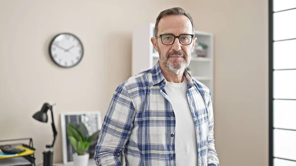 stock image Middle age man business worker standing with relaxed expression at office