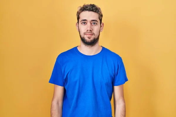 Hispanic Man Beard Standing Yellow Background Relaxed Serious Expression Face — Stok fotoğraf