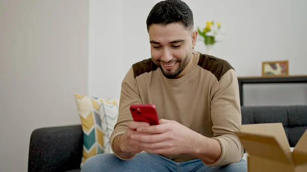 Young Arab Man Using Smartphone Sitting Sofa Home — Stock Fotó