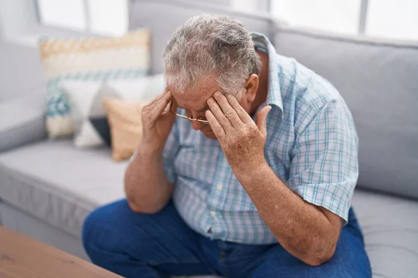 stock image Middle age grey-haired man stressed sitting on sofa at home