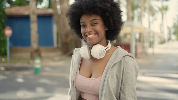 Stock image African american woman smiling confident wearing headphones at street