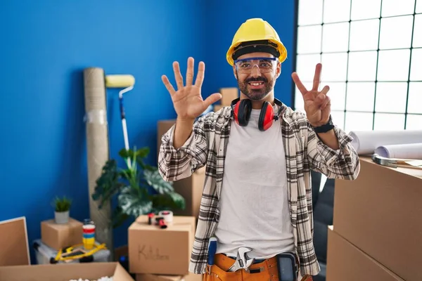 Young Hispanic Man Beard Working Home Renovation Showing Pointing Fingers — Stock Photo, Image