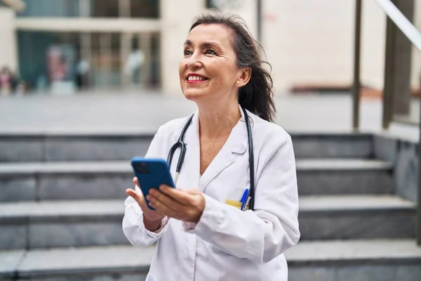 Middle Age Woman Wearing Doctor Uniform Using Smartphone Street — Fotografia de Stock