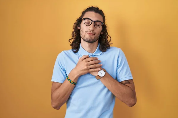 Young Hispanic Man Standing Yellow Background Smiling Hands Chest Closed — 스톡 사진