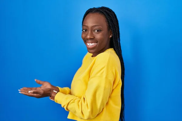 Beautiful Black Woman Standing Blue Background Pointing Aside Hands Open — Stock Photo, Image