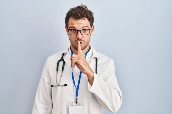 Young Hispanic Man Wearing Doctor Uniform Stethoscope Asking Quiet Finger — Stock Photo, Image