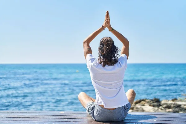 Young Hispanic Man Doing Yoga Exercise Sitting Bench Seaside — Stockfoto