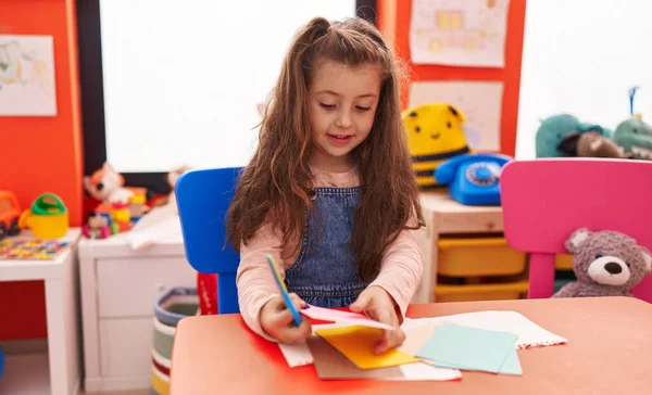 Adorable Hispanic Girl Student Smiling Confident Cutting Paper Kindergarten — Stok fotoğraf