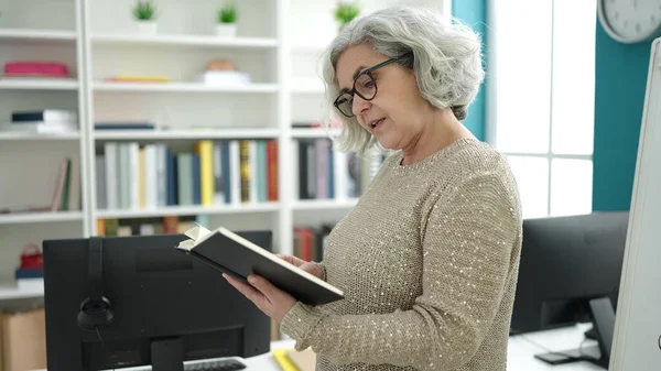 Middle Age Woman Grey Hair Teacher Reading Book University Classroom — Stockfoto
