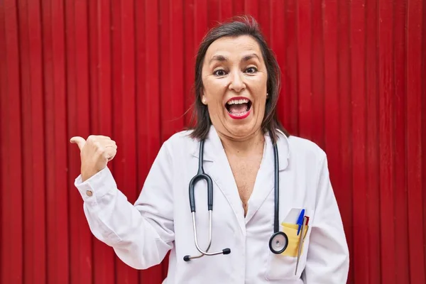 Middle Age Hispanic Woman Wearing Doctor Uniform Stethoscope Pointing Thumb — Stock Photo, Image