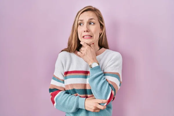 Young Blonde Woman Standing Pink Background Thinking Worried Question Concerned — Fotografia de Stock