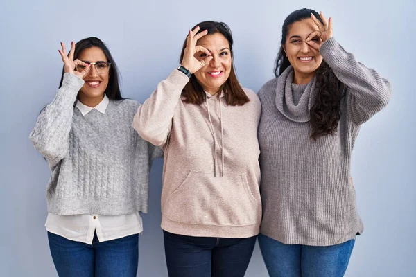 Mother Two Daughters Standing Blue Background Doing Gesture Hand Smiling — Stock Photo, Image