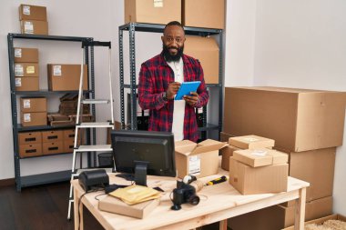 Young african american man ecommerce business worker using touchpad at office