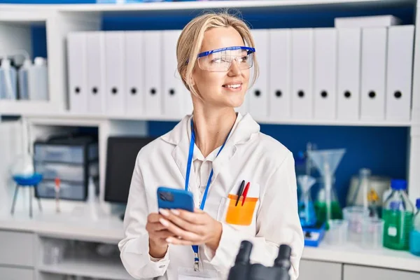 Young Blonde Woman Scientist Using Smartphone Laboratory — Φωτογραφία Αρχείου