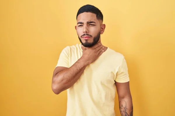 Young Hispanic Man Standing Yellow Background Touching Painful Neck Sore — Fotografia de Stock