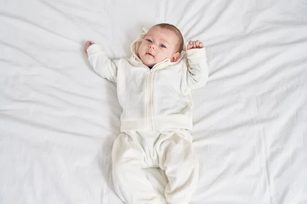 Adorable Caucasian Baby Lying Bed Relaxed Expression Bedroom — Foto Stock